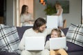 Happy father and son embracing using laptops together at home Royalty Free Stock Photo