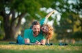 Happy father and son enjoying summer time on vacation in a sunny park. Concept of healthy holiday and family activity. Royalty Free Stock Photo