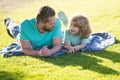 Happy father and son enjoying summer time on vacation in a sunny park. Family camp, vacation, father's day concept. Royalty Free Stock Photo
