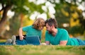 Happy father and son enjoying summer time on vacation in a sunny park. Online lesson. Royalty Free Stock Photo