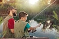 Happy father and son fishing together Royalty Free Stock Photo