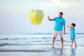 Happy father and son flying fire lantern together