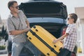 Happy father and son getting ready for road trip on a sunny day Royalty Free Stock Photo