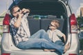 Happy father and son getting ready for road trip on a sunny day Royalty Free Stock Photo