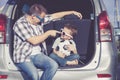 Happy father and son getting ready for road trip on a sunny day Royalty Free Stock Photo