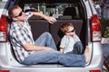 Happy father and son getting ready for road trip on a sunny day Royalty Free Stock Photo