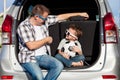 Happy father and son getting ready for road trip on a sunny day. Royalty Free Stock Photo