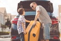 Happy father and son getting ready for road trip on a sunny day. Royalty Free Stock Photo