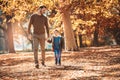 Father and son having fun in autumn park Royalty Free Stock Photo