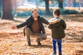 Father and son having fun in autumn park Royalty Free Stock Photo