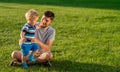 Happy father and son having fun outdoor on meadow Royalty Free Stock Photo