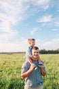 Happy Father and Son having fun over beautiful sky outdoors Royalty Free Stock Photo