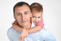 Happy father and son hugging on isolated white background. Royalty Free Stock Photo