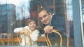 Happy father and son look through the window in a cafe Royalty Free Stock Photo