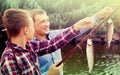 Happy father with son looking at fish on hook Royalty Free Stock Photo