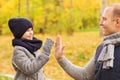 Happy father and son making high five in park Royalty Free Stock Photo