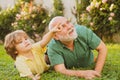 Happy father and son on meadow in summer. Cute child boy hugging his grandfather. Grandfather with Son and Grandson Royalty Free Stock Photo