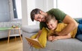 Happy father and son playing with digital tablet at home Royalty Free Stock Photo