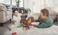 Happy father and son playing with dog at home Royalty Free Stock Photo