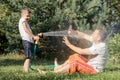 Happy father and son playing in the garden at the day time. Royalty Free Stock Photo