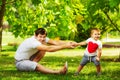 Happy father and son playing together having fun in the green summer park on a warm sunny day. Family and love. Royalty Free Stock Photo