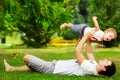 Happy father and son playing together having fun in the green summer park on a warm sunny day. Family and love. Royalty Free Stock Photo