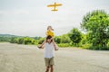 Happy father and son playing with toy airplane against old runway background. Traveling with kids concept Royalty Free Stock Photo