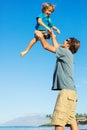 Happy father and son playing on tropical beach, carefree happy f Royalty Free Stock Photo