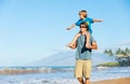 Happy father and son playing on tropical beach, carefree happy f Royalty Free Stock Photo