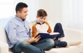 Happy father and son reading book at home Royalty Free Stock Photo