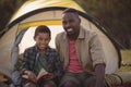 Happy father and son reading book in park Royalty Free Stock Photo