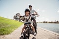 Father and son riding their bikes having fun together in the park by the lake Royalty Free Stock Photo