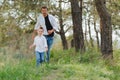 Happy father and son sitting in the park. Smiling young man spending time together with his son Royalty Free Stock Photo