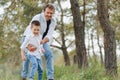 Happy father and son sitting in the park. Smiling young man spending time together with his son Royalty Free Stock Photo