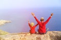 Happy father and son sitting on top of a mountain Royalty Free Stock Photo