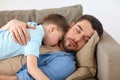 Happy father and son sleeping on sofa at home Royalty Free Stock Photo