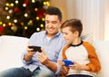 Happy father and son with smartphones on christmas Royalty Free Stock Photo