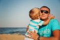 Happy father and son together at beach. Son is kissing his father Royalty Free Stock Photo