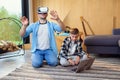 Excited father and son testing virtual reality headset playing augmented video reality games. Royalty Free Stock Photo