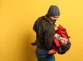 Happy father and son in warm clothes playing on background, space for text. Winter vacation Royalty Free Stock Photo