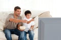 Happy father and son watching television Royalty Free Stock Photo