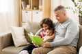 Happy father with sons reading book at home Royalty Free Stock Photo