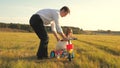 Happy father teaches little daughter to ride a bike. Dad plays with small child on lawn. kid learns to ride bicycle Royalty Free Stock Photo