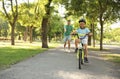 Happy father teaching his son to ride bicycle Royalty Free Stock Photo