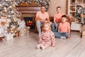 Happy father and three children near the Christmas tree. the same clothes. family photo shoot Royalty Free Stock Photo