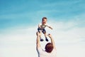 Happy father throwing his son child into the air, carefree having fun outdoors Royalty Free Stock Photo