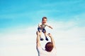 Happy father throws son child into the air,