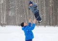 Happy father throws up her young son in park