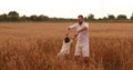 Happy father twisting child on meadow.