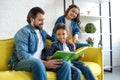 happy father with two cute kids reading book together Royalty Free Stock Photo